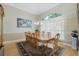 Formal dining room featuring hardwood floors, a large window, a chandelier, and seating for eight at 415 Ruby Lake Pl, Winter Haven, FL 33884
