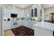 Bright kitchen featuring white cabinetry, modern appliances, quartz countertops, and tile flooring at 415 Ruby Lake Pl, Winter Haven, FL 33884