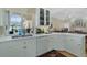 Bright kitchen featuring white cabinetry, quartz countertops, modern appliances, and decorative chandelier at 415 Ruby Lake Pl, Winter Haven, FL 33884