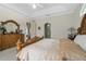 Spacious main bedroom with decorative wood furniture and tray ceiling at 415 Ruby Lake Pl, Winter Haven, FL 33884