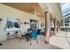 Covered patio features stylish outdoor seating, ceiling fans, and architectural columns at 415 Ruby Lake Pl, Winter Haven, FL 33884