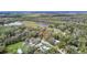 An aerial view of a home surrounded by lush greenery and a tranquil lake setting at 428 Garrett Ridge Ct, Winter Haven, FL 33880