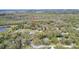 An aerial view of the property nestled among trees with lake access nearby at 428 Garrett Ridge Ct, Winter Haven, FL 33880