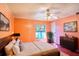 Comfortable bedroom featuring an area rug, wooden floors, and natural light from the window at 428 Garrett Ridge Ct, Winter Haven, FL 33880