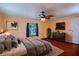 Bright bedroom features hardwood floors, neutral walls, ceiling fan, and window at 428 Garrett Ridge Ct, Winter Haven, FL 33880