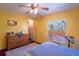 Bedroom featuring yellow walls, wood floors and lots of light at 428 Garrett Ridge Ct, Winter Haven, FL 33880