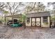 View of a large utility shed with double doors and additional carport at 428 Garrett Ridge Ct, Winter Haven, FL 33880