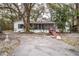 Charming single-story home with a screened-in porch and mature trees in a lush backyard at 428 Garrett Ridge Ct, Winter Haven, FL 33880