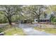 Spacious front yard with a covered carport and shed at 428 Garrett Ridge Ct, Winter Haven, FL 33880