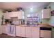Cozy kitchen featuring white cabinets, butcher block countertops and a stainless steel sink at 428 Garrett Ridge Ct, Winter Haven, FL 33880