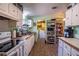 Vintage kitchen with white cabinetry, wood countertops and a large sink at 428 Garrett Ridge Ct, Winter Haven, FL 33880