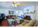 Bright living room with fireplace, ceiling fan and warm carpeting at 428 Garrett Ridge Ct, Winter Haven, FL 33880