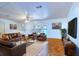 Cozy living room with bay window, tile floors, and brown leather furniture at 428 Garrett Ridge Ct, Winter Haven, FL 33880
