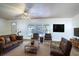 Cozy living room with neutral rug, leather furniture and exterior views at 428 Garrett Ridge Ct, Winter Haven, FL 33880
