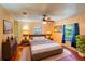 This main bedroom has a ceiling fan and lamps on either side of the bed at 428 Garrett Ridge Ct, Winter Haven, FL 33880