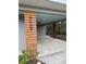 Close-up of stylish wood carport support with modern house number detail; features updated design at 4909 Fleetwood St, Lake Wales, FL 33859