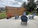 Relaxing backyard patio showcases a modern privacy screen, comfortable seating around a fire pit, and lush landscaping at 4909 Fleetwood St, Lake Wales, FL 33859