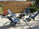 Inviting backyard patio area featuring a fire pit, stylish Adirondack chairs, and a modern privacy fence at 4909 Fleetwood St, Lake Wales, FL 33859