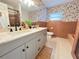 Updated bathroom with double vanity, stylish wallpaper, and sleek fixtures at 4909 Fleetwood St, Lake Wales, FL 33859