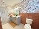 Bathroom featuring double vanity, stylish wallpaper, and a toilet at 4909 Fleetwood St, Lake Wales, FL 33859
