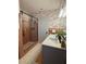 Bathroom featuring a shower with a glass door and dual sink vanity at 4909 Fleetwood St, Lake Wales, FL 33859