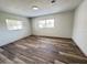 Bedroom featuring neutral paint, laminate wood flooring, and natural light from the windows at 4909 Fleetwood St, Lake Wales, FL 33859