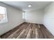 This bedroom features a light, airy feel with wood-look floors and neutral paint at 4909 Fleetwood St, Lake Wales, FL 33859