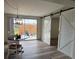 Bright dining area with a modern light fixture, sliding barn doors, and view to the backyard at 4909 Fleetwood St, Lake Wales, FL 33859