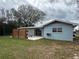 Exterior view of the home showcases a backyard patio area with privacy fence and a beautifully landscaped yard at 4909 Fleetwood St, Lake Wales, FL 33859