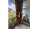 Cozy front porch detail with modern wooden support column, landscaping, and a space for book display at 4909 Fleetwood St, Lake Wales, FL 33859