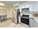 Updated kitchen with stainless appliances, modern hardware, and an adjacent dining nook with chairs at 4909 Fleetwood St, Lake Wales, FL 33859
