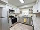 Modern updated kitchen featuring stainless steel appliances, gray cabinets, and granite countertops at 4909 Fleetwood St, Lake Wales, FL 33859