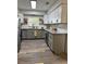 Bright kitchen featuring stainless steel appliances, granite countertops, and two-tone white and gray cabinets at 4909 Fleetwood St, Lake Wales, FL 33859