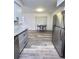 Open concept kitchen showcasing stainless steel refrigerator, wood-look flooring, and an eat-in nook at 4909 Fleetwood St, Lake Wales, FL 33859