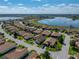 An aerial view shows the property in a tranquil neighborhood setting near a scenic lake and lush surroundings at 5304 Nicklaus Dr, Winter Haven, FL 33884