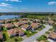 An aerial view showcases a neighborhood near a lake and beautiful scenery at 5304 Nicklaus Dr, Winter Haven, FL 33884