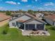 Aerial view of the backyard with a lanai and patio area, well-manicured lawn, and landscaping at 5304 Nicklaus Dr, Winter Haven, FL 33884