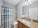 Cozy bathroom featuring a granite vanity top, neutral paint, and a shower-tub combination at 5304 Nicklaus Dr, Winter Haven, FL 33884
