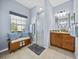 Bright bathroom with a glass-enclosed shower, a granite-topped vanity, and a window seat with storage at 5304 Nicklaus Dr, Winter Haven, FL 33884