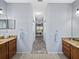 Dual vanities enhance this pass-through bathroom featuring neutral paint and carpet leading to the bedroom at 5304 Nicklaus Dr, Winter Haven, FL 33884
