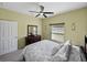 Neutral bedroom with carpet, neutral walls, a ceiling fan and window with blinds at 5304 Nicklaus Dr, Winter Haven, FL 33884