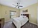Neutral bedroom with carpet, neutral walls, a ceiling fan and window with blinds at 5304 Nicklaus Dr, Winter Haven, FL 33884