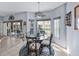 Cozy dining area with views of the patio through sliding glass doors and large windows at 5304 Nicklaus Dr, Winter Haven, FL 33884