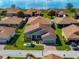 An aerial view of a light grey single-story home with a well-manicured front yard and charming curb appeal at 5304 Nicklaus Dr, Winter Haven, FL 33884