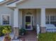 Charming front porch with decorative elements, lush landscaping, and a welcoming entrance at 5304 Nicklaus Dr, Winter Haven, FL 33884