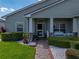 Inviting front porch with decorative columns and a well-manicured garden, enhancing curb appeal at 5304 Nicklaus Dr, Winter Haven, FL 33884