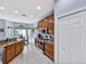 Well-lit kitchen boasts stainless steel appliances, wooden cabinetry, and eat-in dining area at 5304 Nicklaus Dr, Winter Haven, FL 33884