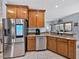 Modern kitchen featuring stainless steel appliances, wood cabinets, and granite countertops at 5304 Nicklaus Dr, Winter Haven, FL 33884