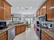 Well-equipped kitchen with wooden cabinets, granite countertops, and stainless steel appliances at 5304 Nicklaus Dr, Winter Haven, FL 33884