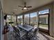 Enclosed lanai with ceiling fans, brick floor, comfortable seating and view of the manicured backyard at 5304 Nicklaus Dr, Winter Haven, FL 33884